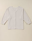 Haut ample à col en V et fentes latérales en tricot gaufré blanc