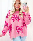 Pull ample à épaules tombantes et motif nœud rose