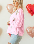 Sweat-shirt oversize rose clair à manches lanternes et nœud brodé
