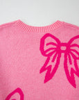 Pull ample à épaules tombantes et motif nœud rose