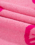Pull ample à épaules tombantes et motif nœud rose