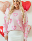 Pull ample à manches bouffantes en forme de cœur rose