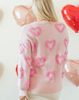 Pull ample à manches bouffantes en forme de cœur rose
