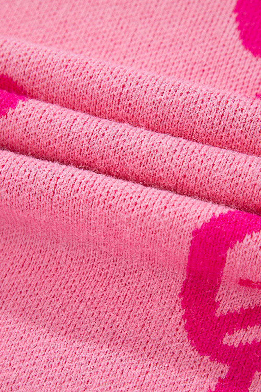 Maglione largo con spalla cadente e motivo fiocco rosa